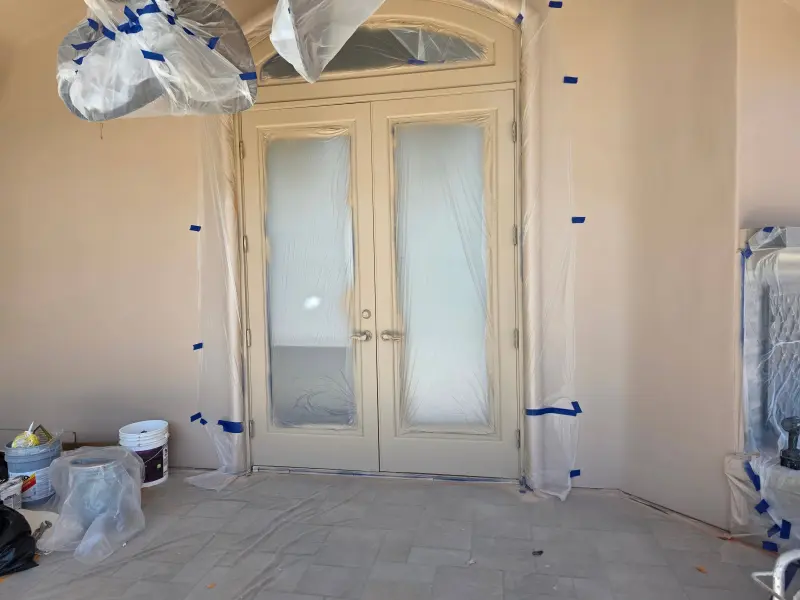 Stucco coating Indian Wells preparation with protective sheeting on doors and trim surfaces