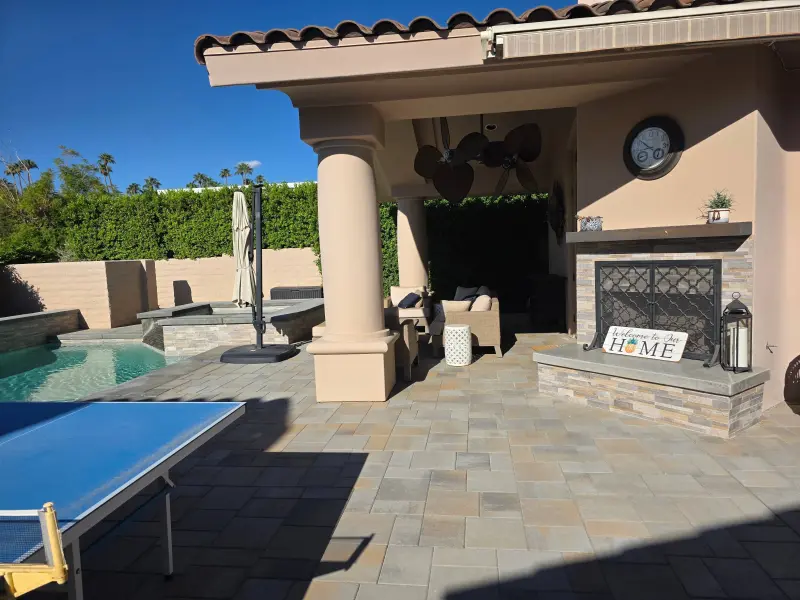 Indian Wells patio after elastomeric paint with restored columns, pool, and fireplace area