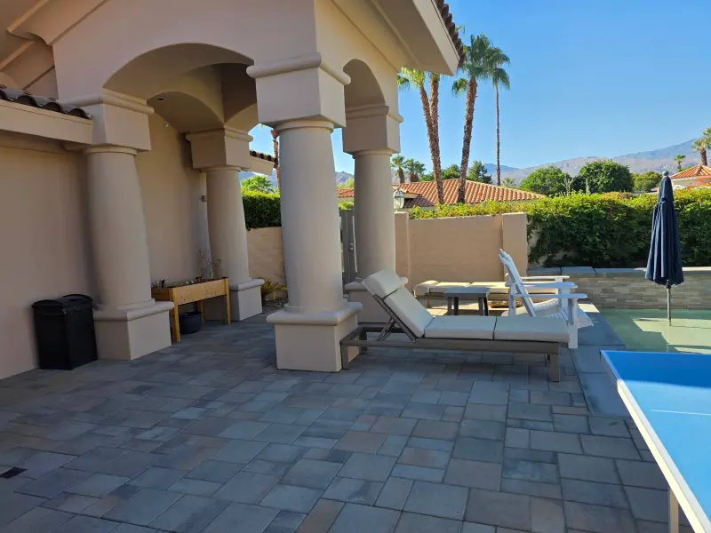 Stucco coating Indian Wells pool deck with freshly painted columns and exterior walls