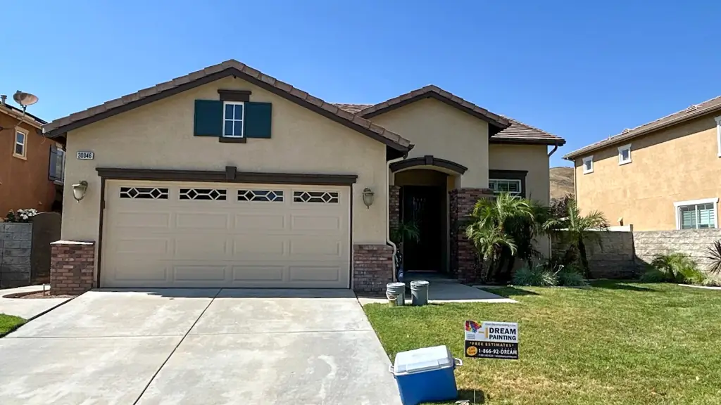 Stucco painting Highland home after with smooth finish and decorative architectural shutters
