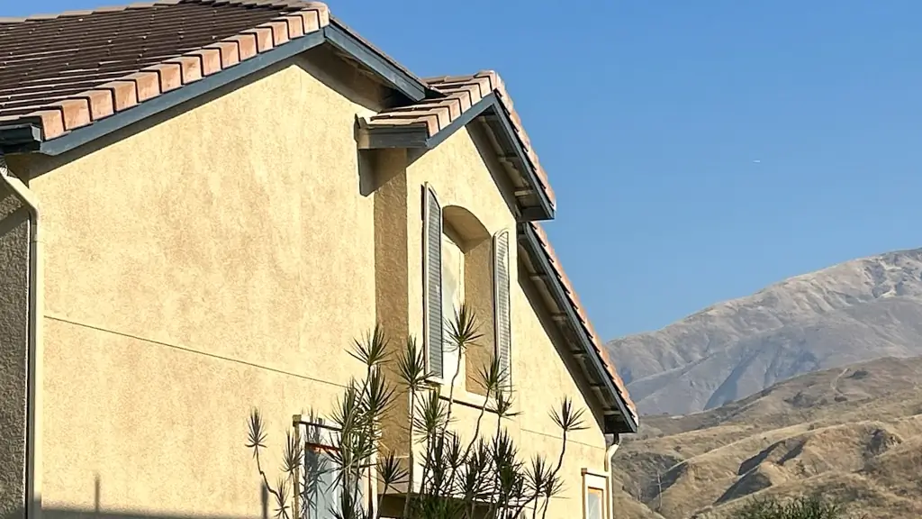 Close-up of professional stucco painting in Highland showing premium UV-resistant finish