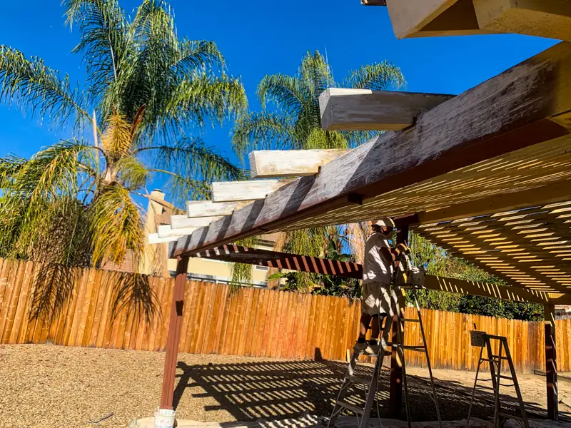 Exterior painting Redlands before — weathered porch area with peeling paint and sun damage