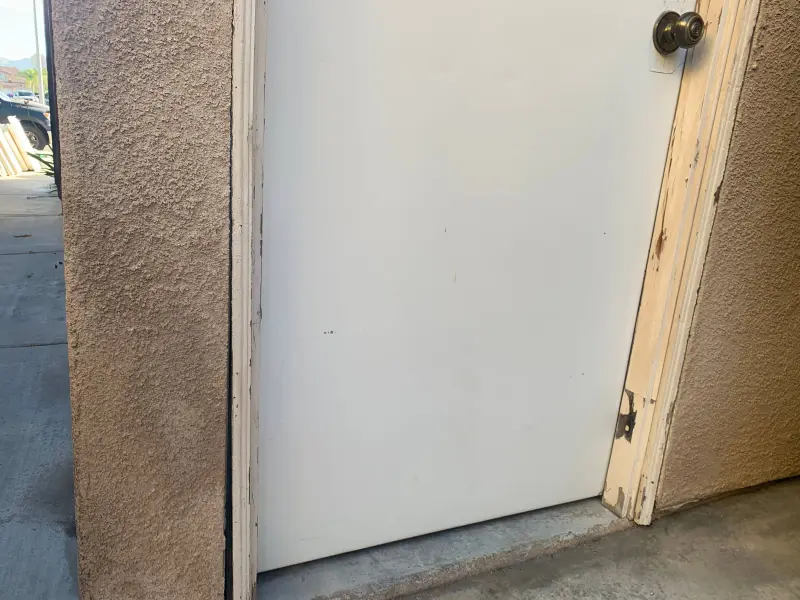 Before exterior painting in Riverside CA — weathered door trim and faded stucco needing surface prep