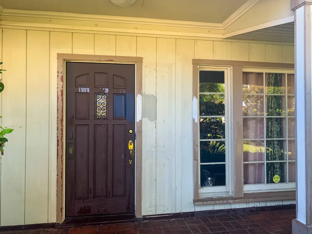 Front porch before exterior painting San Gabriel with damaged wood siding and worn door