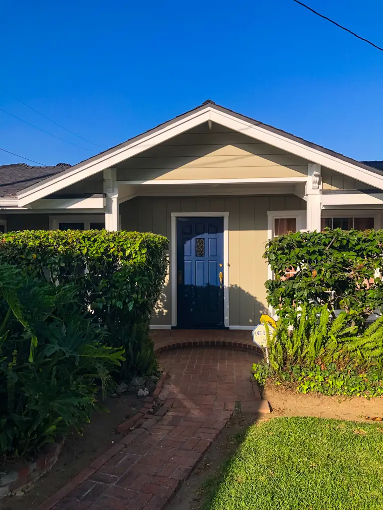 Blue accent front door after exterior painting San Gabriel with fresh white trim detail