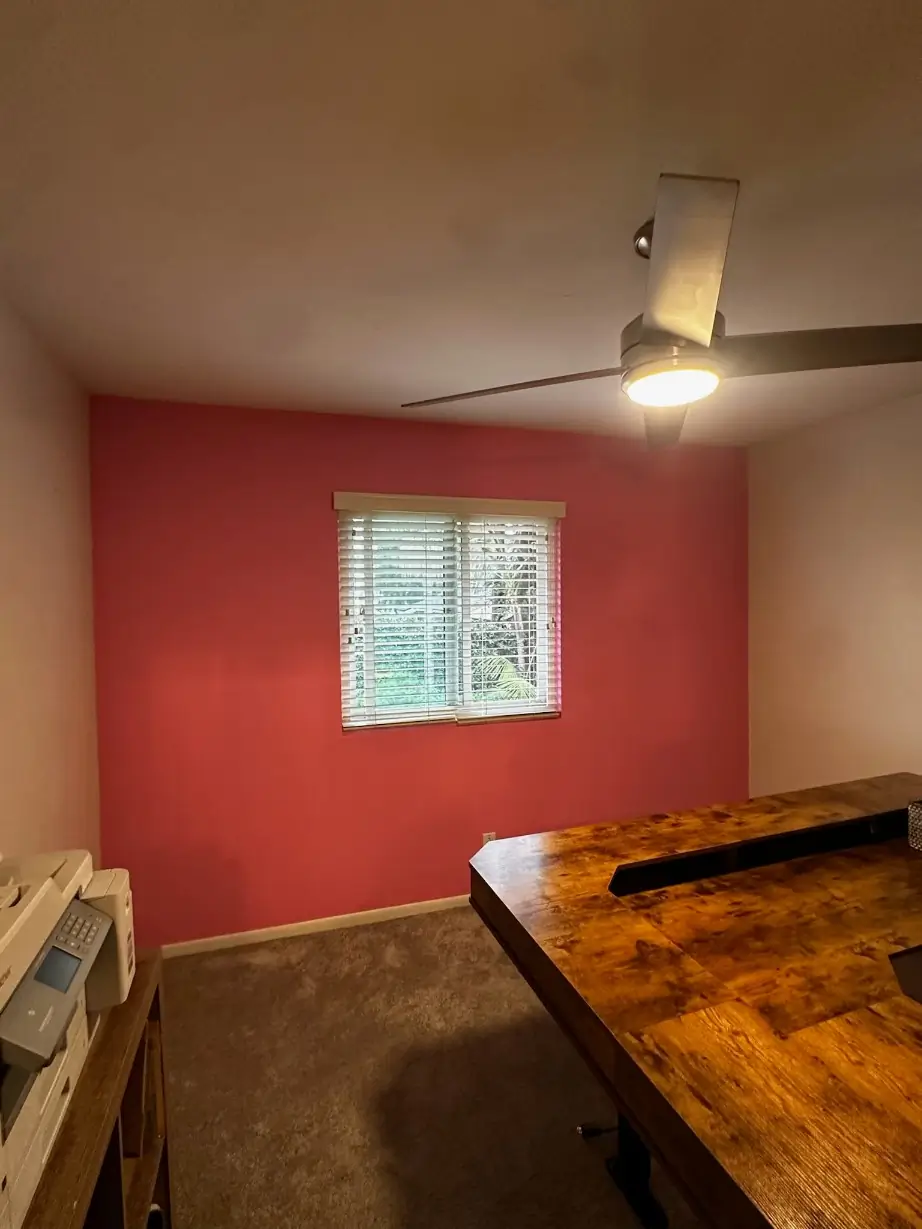 Professional painting Whittier — warm pink accent wall in kids room before finishing coat