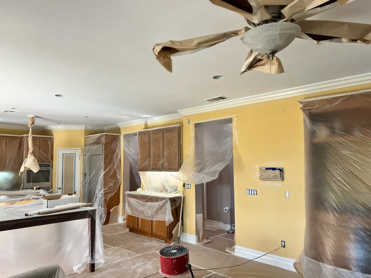 Kitchen painting Whittier — plastic covering protects cabinets and counters during wall prep