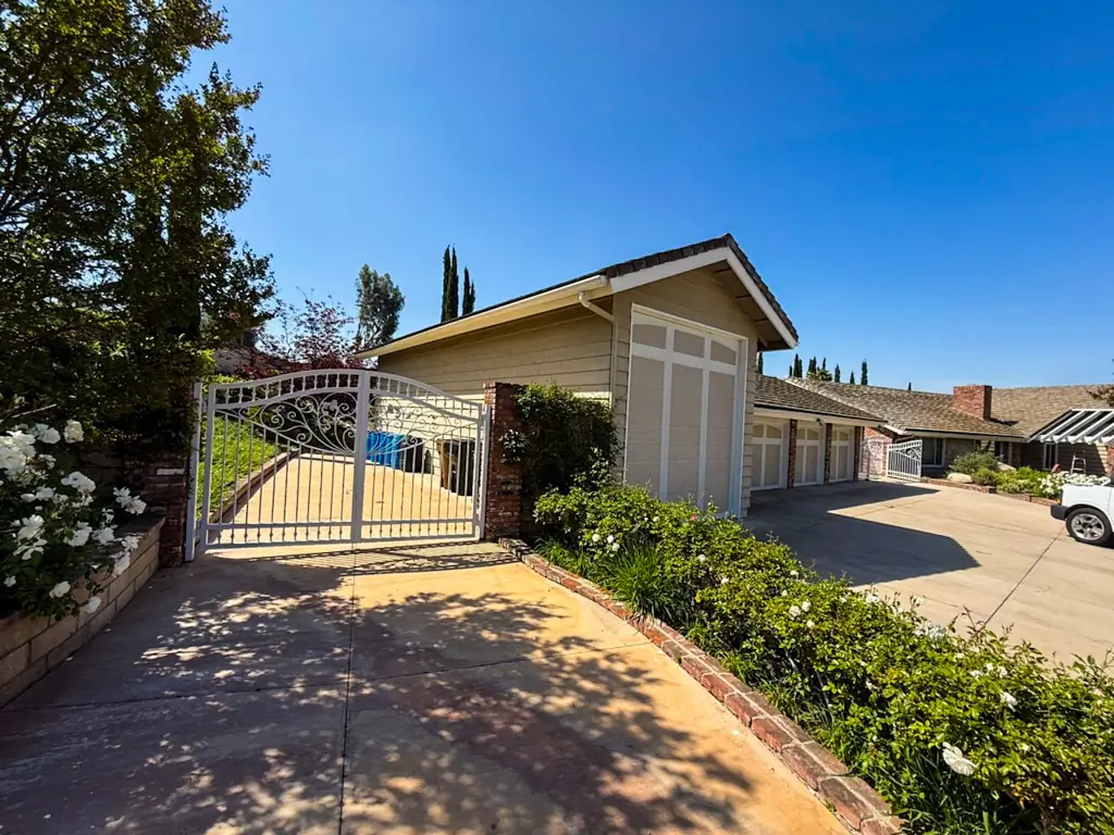 Exterior painting Yorba Linda before showing driveway entrance and faded stucco garage