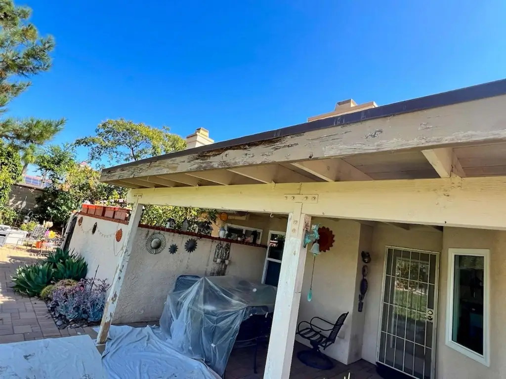 Weathered patio cover with worn paint before exterior painting in Moreno Valley